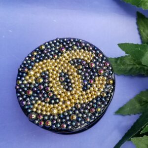 Elegant round compact with leaf accents
