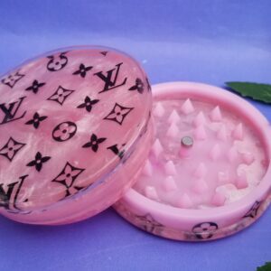 Open pink grinder on purple background