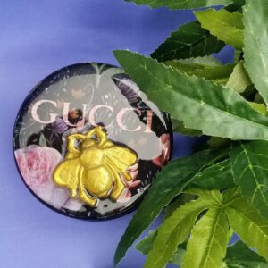 Decorative compact on purple background
