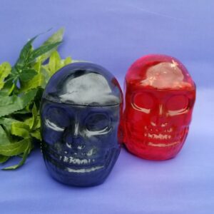 Colorful skull candles on purple background