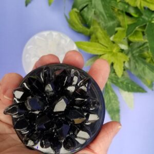 Hand holding black crystal object
