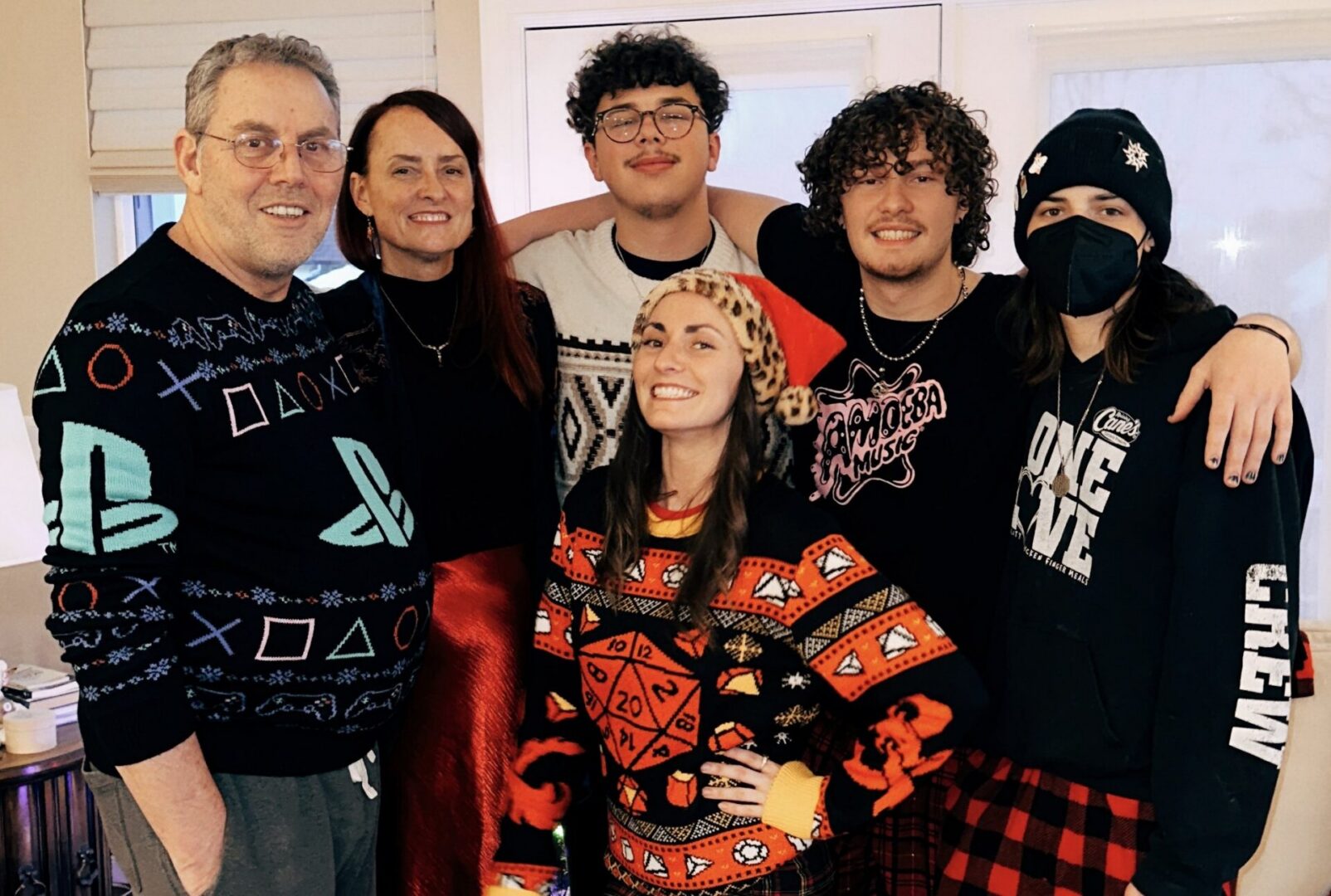 Family wearing festive sweaters smiling together