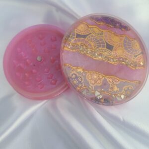 Elegant pink grinder with intricate designs