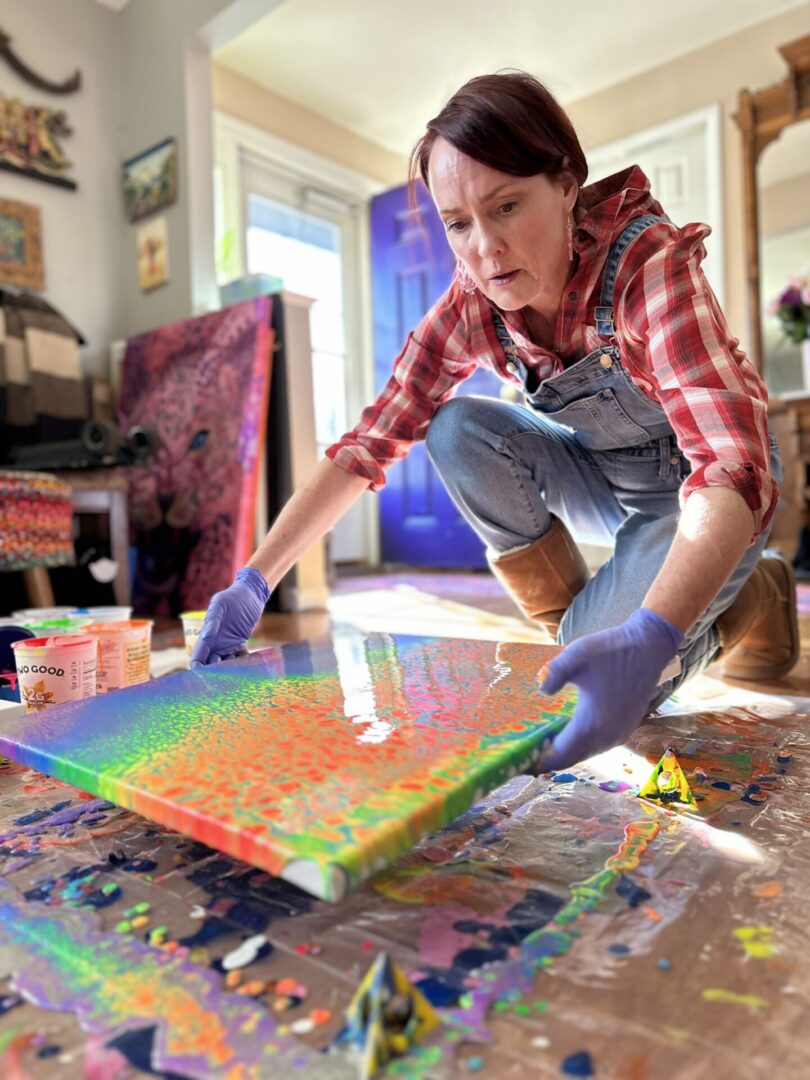 Woman pouring paint on canvas