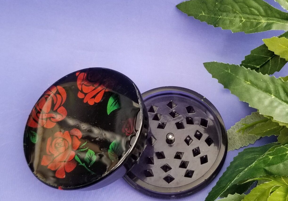 Black grinder with red rose design