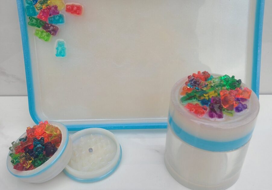 Colorful gummy bears on tray and jars