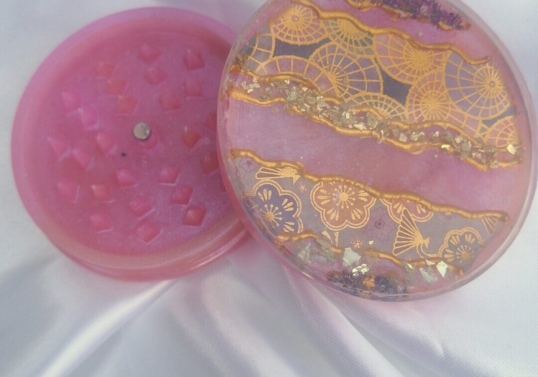 Elegant pink grinder with intricate designs