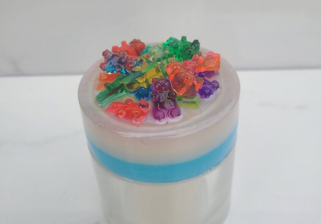 Scented candle topped with gummy bear shapes