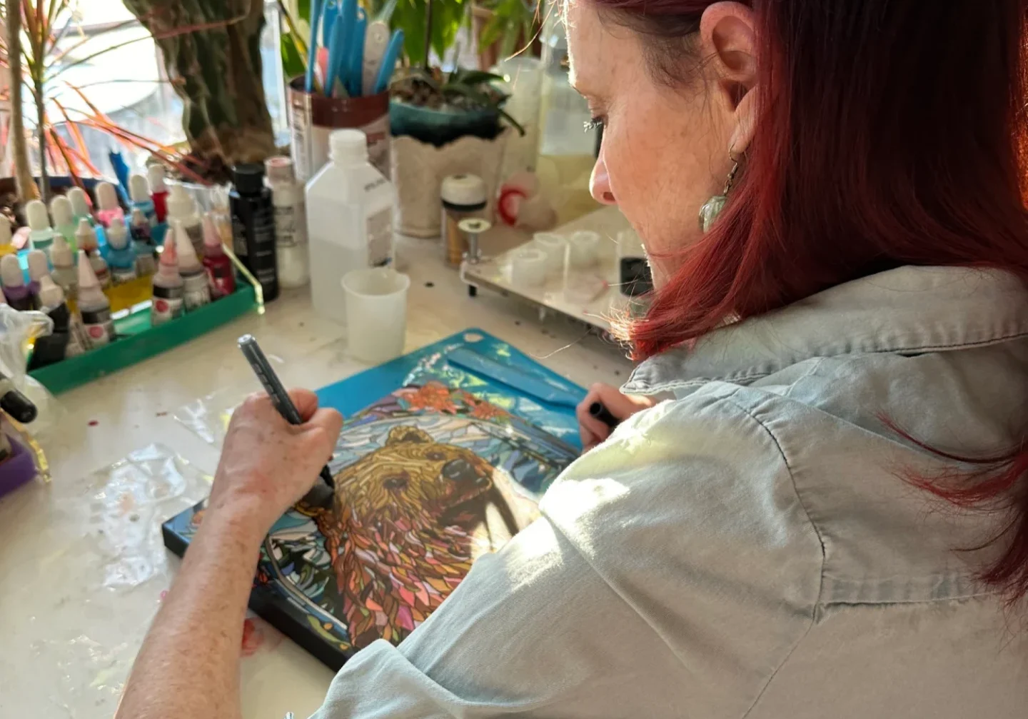 Painter working amidst plants and sunlight
