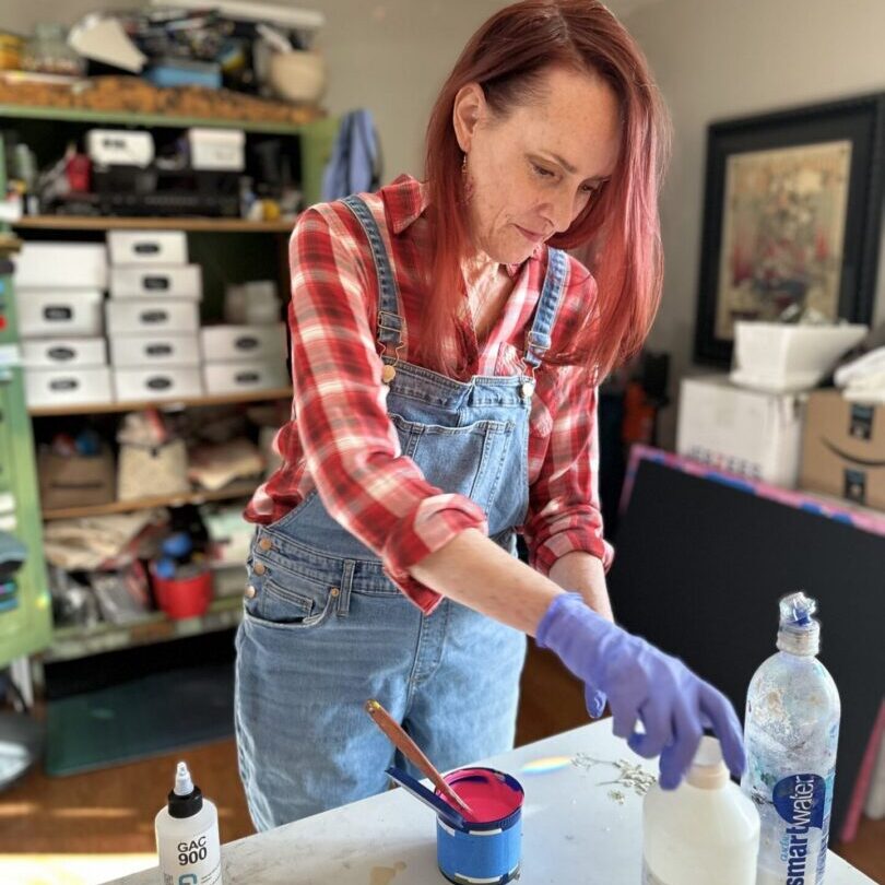 Person preparing art materials on table